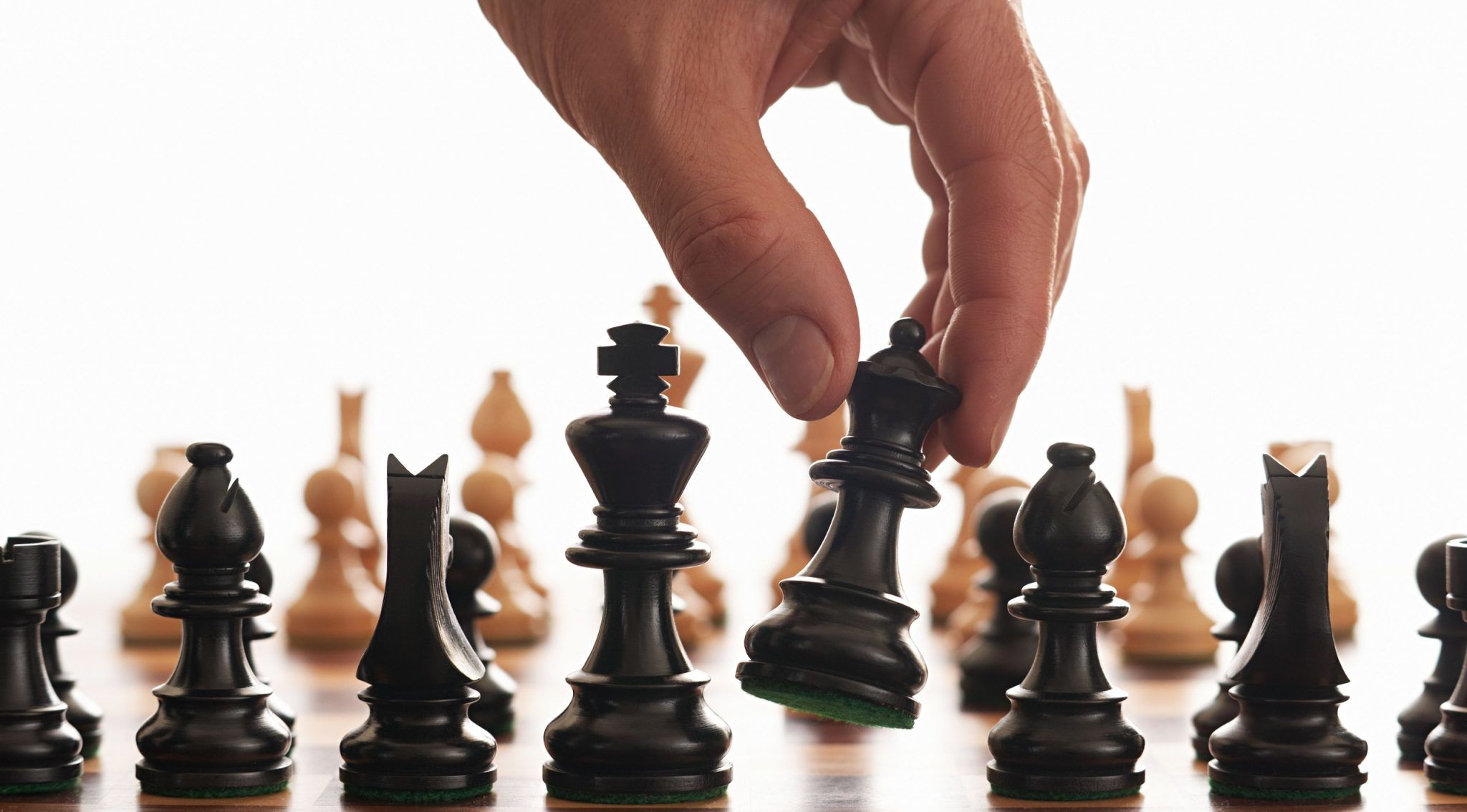 A hand moving a chess piece during a game ROK Dijital Google Ads